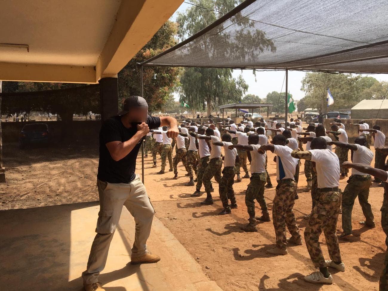 R&H close-protection officer shielding a principal in transit